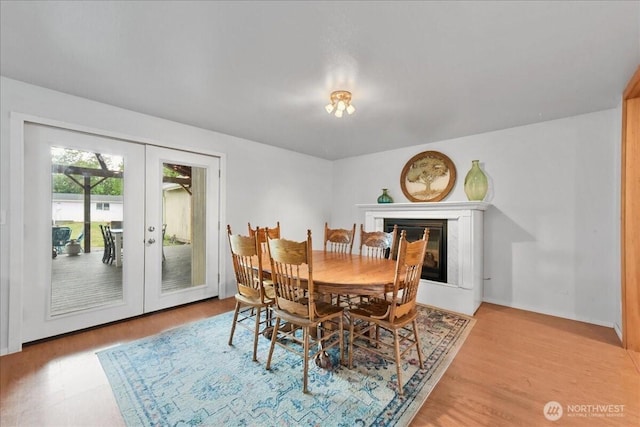 32509 80th Dr NW, Stanwood, WA 98292 - dining space featuring french doors, light wood-type flooring, and a fireplace