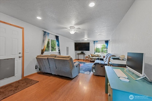 32509 80th Dr NW, Stanwood, WA 98292 - living area featuring light wood finished floors, a textured ceiling, a ceiling fan, baseboards, and recessed lighting