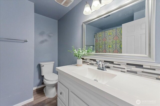 32509 80th Dr NW, Stanwood, WA 98292 - full bathroom featuring vanity, toilet, tasteful backsplash, and wood finished floors
