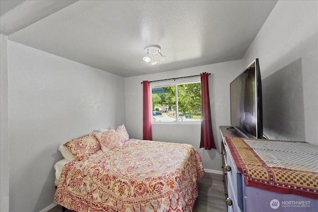 32509 80th Dr NW, Stanwood, WA 98292 - bedroom featuring dark wood-style floors, baseboards, and a textured ceiling