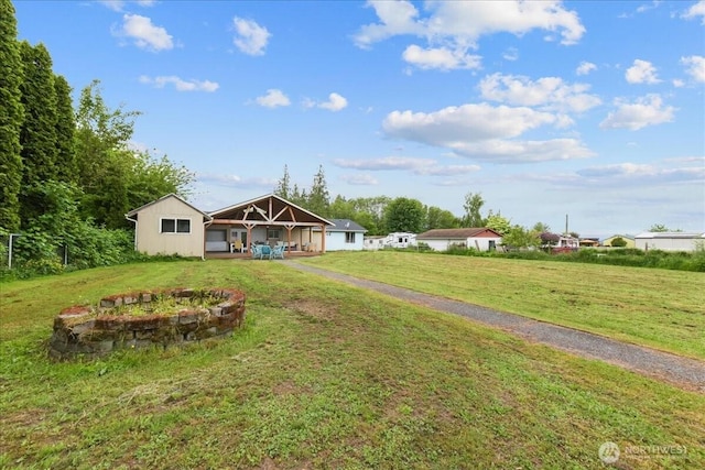 32509 80th Dr NW, Stanwood, WA 98292 - back of house with a yard and a fire pit