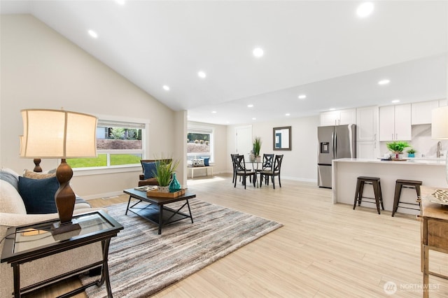 20103 75th Ave NE, Kenmore, WA 98028 - living area featuring recessed lighting, light wood finished floors, high vaulted ceiling, and baseboards