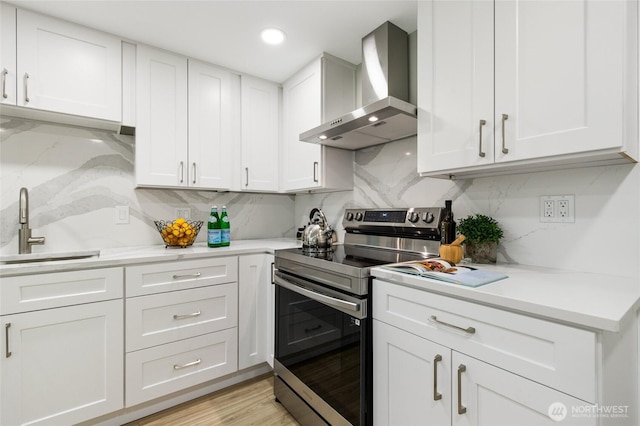 20103 75th Ave NE, Kenmore, WA 98028 - kitchen with wall chimney range hood, stainless steel electric range, a sink, decorative backsplash, and light countertops
