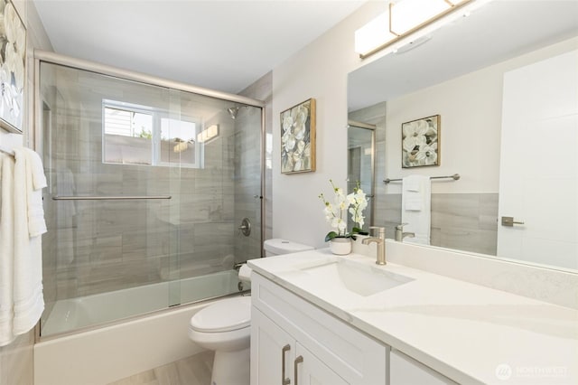 20103 75th Ave NE, Kenmore, WA 98028 - bathroom with toilet, vanity, enclosed tub / shower combo, and wood finished floors