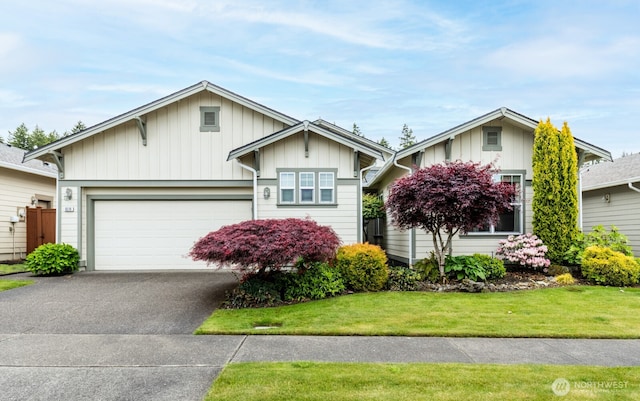view of front of home featuring a garage, driveway, board and batten siding, and a front lawn