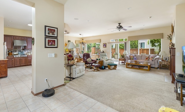 living room with ceiling fan, light tile patterned flooring, a chandelier, and baseboards