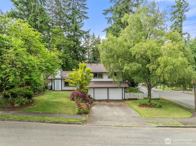 1933 Dayton Dr SE, Renton, WA 98055 - view of property hidden behind natural elements with an attached garage, asphalt driveway, and roof with shingles