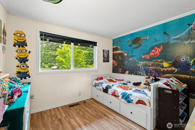 1933 Dayton Dr SE, Renton, WA 98055 - bedroom featuring a textured ceiling, wood finished floors, baseboards, and crown molding