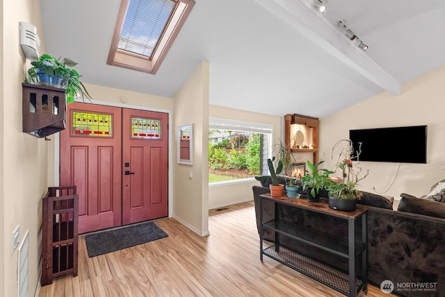 1933 Dayton Dr SE, Renton, WA 98055 - foyer entrance with a skylight, light wood-style floors, baseboards, and rail lighting
