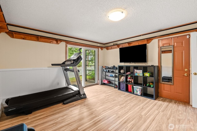 1933 Dayton Dr SE, Renton, WA 98055 - exercise room featuring a textured ceiling and wood finished floors