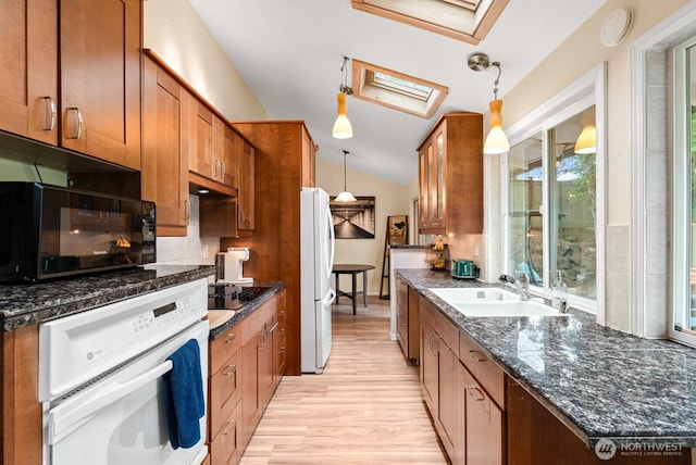 1933 Dayton Dr SE, Renton, WA 98055 - kitchen with white appliances, a skylight, a sink, lofted ceiling, and brown cabinets