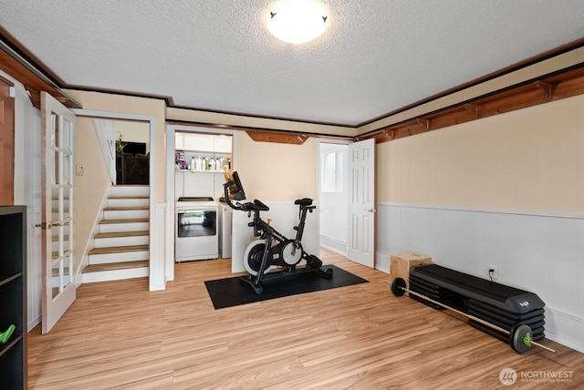 1933 Dayton Dr SE, Renton, WA 98055 - exercise room featuring washer / dryer, a textured ceiling, light wood-style flooring, and baseboards