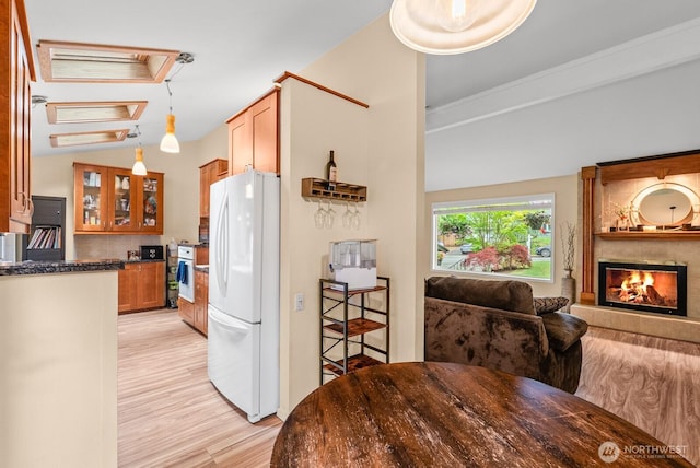1933 Dayton Dr SE, Renton, WA 98055 - kitchen with white appliances, light wood-style floors, glass insert cabinets, a fireplace, and hanging light fixtures