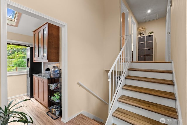 1933 Dayton Dr SE, Renton, WA 98055 - staircase featuring wood finished floors, baseboards, and a skylight