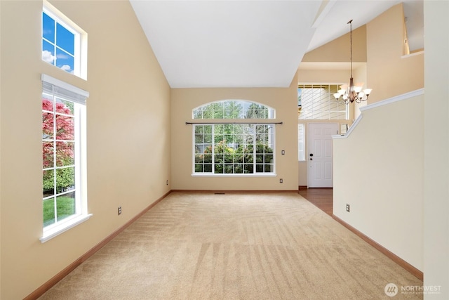 1521 55th Ct SE, Auburn, WA 98092 - empty room featuring high vaulted ceiling, carpet floors, a chandelier, and baseboards