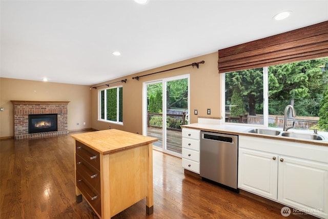 1521 55th Ct SE, Auburn, WA 98092 - kitchen with dishwasher, a sink, butcher block counters, dark wood-style flooring, and a brick fireplace