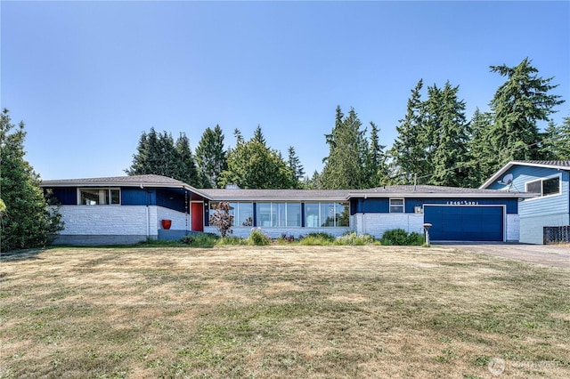 1245 SW 301st St, Federal Way, WA 98023 - view of front of house featuring a garage, a front yard, and stone siding