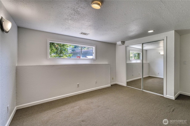 1245 SW 301st St, Federal Way, WA 98023 - unfurnished bedroom with carpet flooring, a textured ceiling, baseboards, a closet, and a textured wall