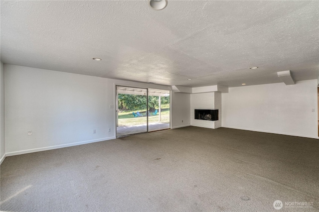 1245 SW 301st St, Federal Way, WA 98023 - unfurnished living room with a textured ceiling, carpet, baseboards, a brick fireplace, and recessed lighting