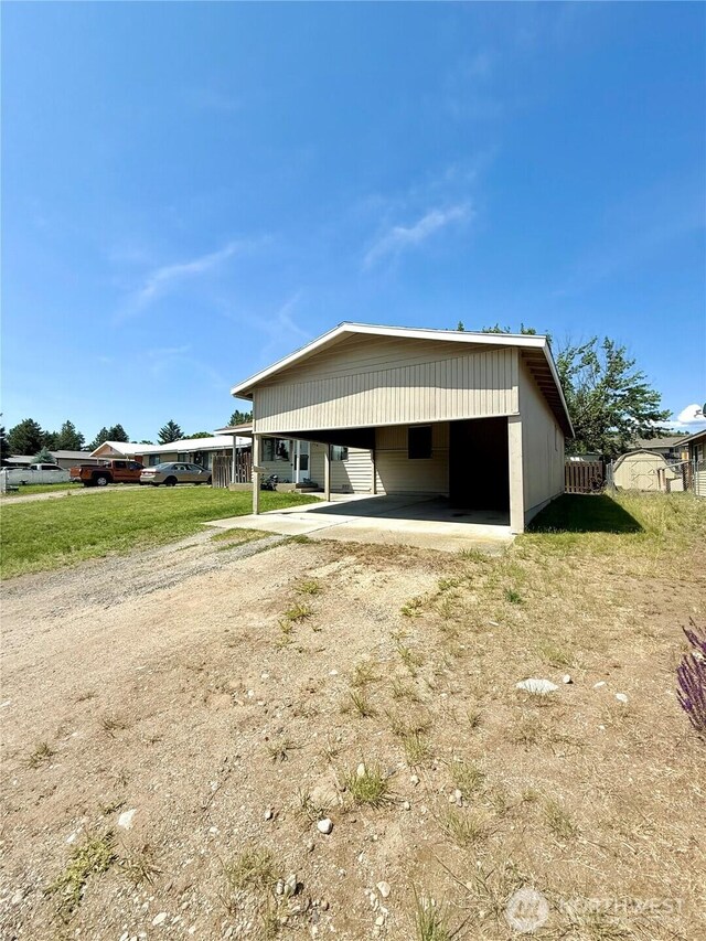 718 Ridge Pl, Omak, WA 98841 - view of side of property with driveway and an attached carport