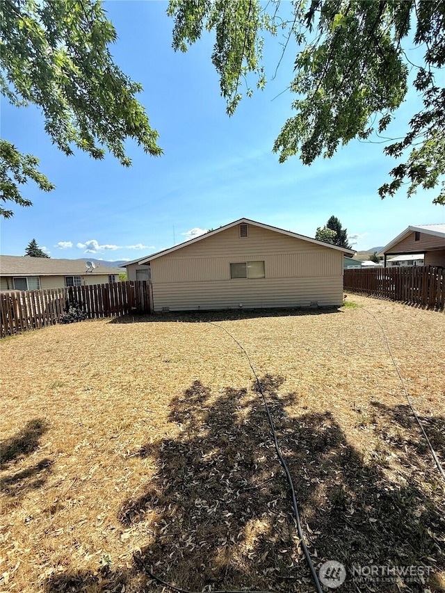 718 Ridge Pl, Omak, WA 98841 - rear view of house with a fenced backyard