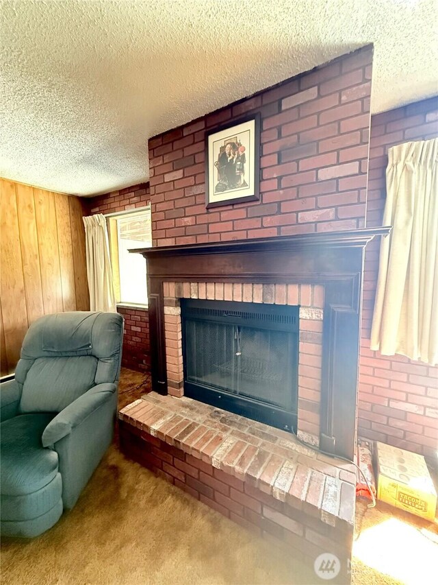 718 Ridge Pl, Omak, WA 98841 - detailed view of a brick fireplace, a textured ceiling, carpet floors, wood walls, and brick wall