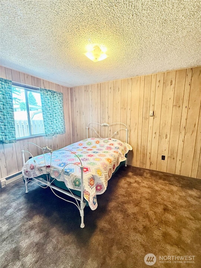 718 Ridge Pl, Omak, WA 98841 - carpeted bedroom featuring wood walls, a textured ceiling, and baseboard heating