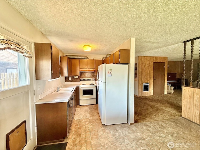 718 Ridge Pl, Omak, WA 98841 - kitchen featuring white appliances, light countertops, brown cabinets, a sink, and a textured ceiling