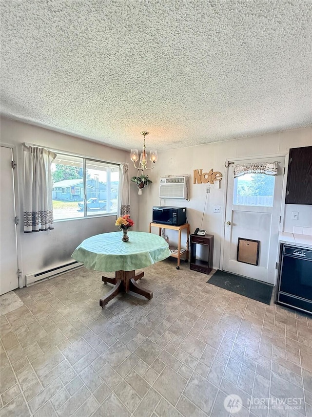718 Ridge Pl, Omak, WA 98841 - dining space with baseboard heating, a wall mounted AC, plenty of natural light, a textured ceiling, and a chandelier