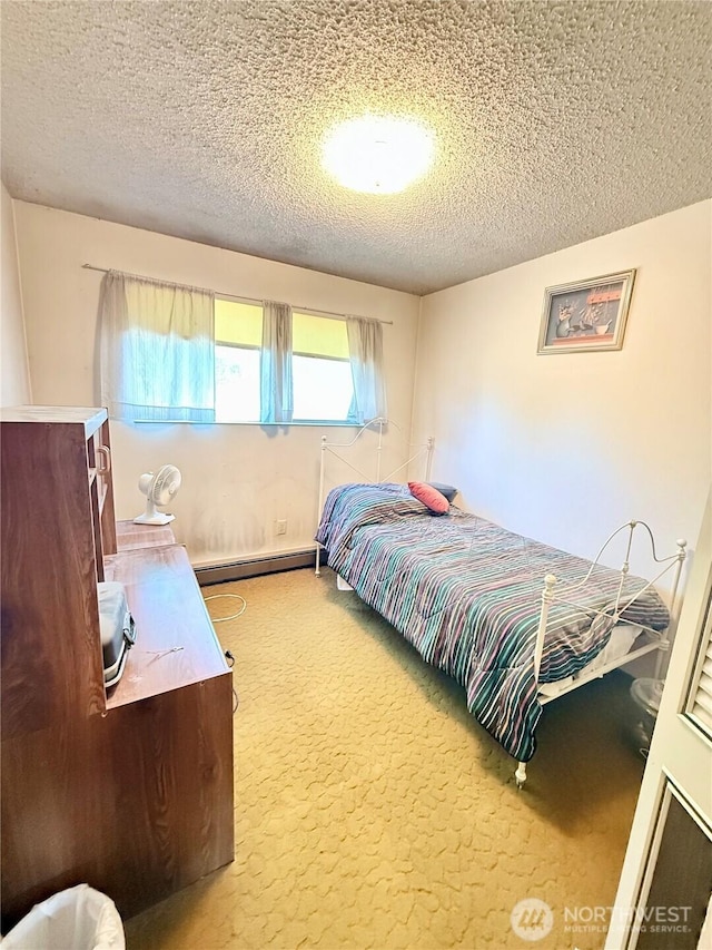 718 Ridge Pl, Omak, WA 98841 - carpeted bedroom featuring a baseboard heating unit and a textured ceiling