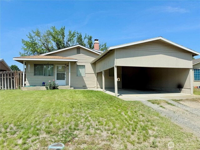 718 Ridge Pl, Omak, WA 98841 - view of front of property with driveway, a carport, and a chimney