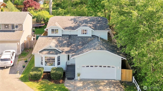 1416 116th Dr SE, Lake Stevens, WA 98258 - view of front of house with a trampoline, concrete driveway, an attached garage, and a high end roof