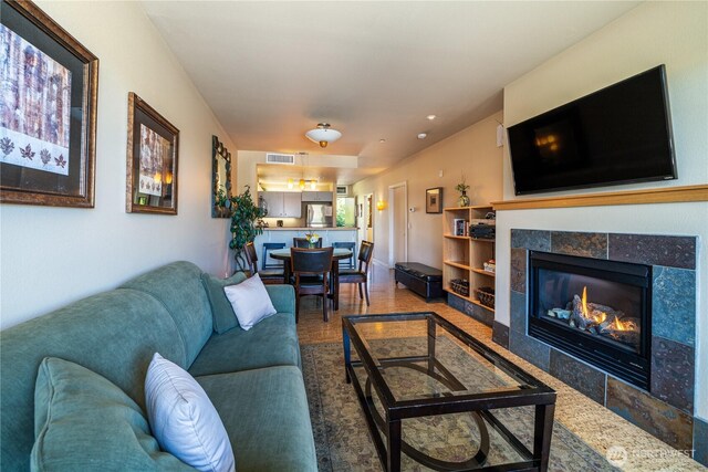 2220 W Woodin Ave Unit 210, Chelan, WA 98816 - living room featuring a tile fireplace