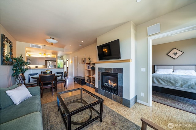 2220 W Woodin Ave Unit 210, Chelan, WA 98816 - living area featuring a tiled fireplace and baseboards