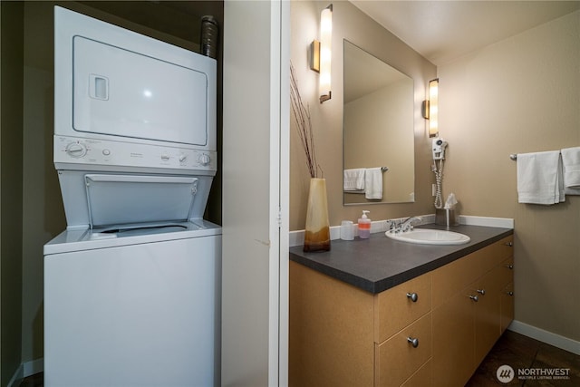 2220 W Woodin Ave Unit 210, Chelan, WA 98816 - bathroom featuring estacked washer and dryer, vanity, and baseboards