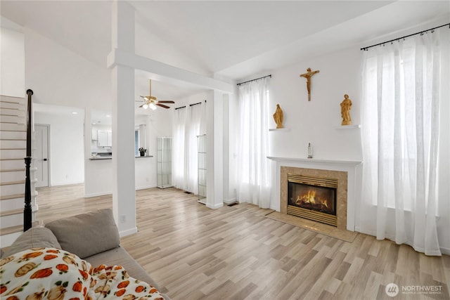 12018 SE 312th Pl Unit 3B, Auburn, WA 98092 - living area with wood finished floors, a tiled fireplace, a ceiling fan, and high vaulted ceiling