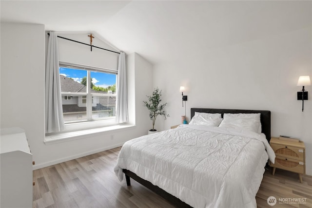 12018 SE 312th Pl Unit 3B, Auburn, WA 98092 - bedroom featuring lofted ceiling, wood finished floors, and baseboards