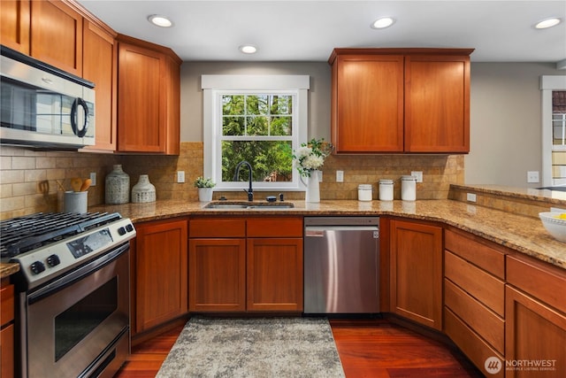 830 15th Ave Unit A, Seattle, WA 98122 - kitchen featuring stainless steel appliances, a sink, dark wood-style flooring, light stone countertops, and recessed lighting