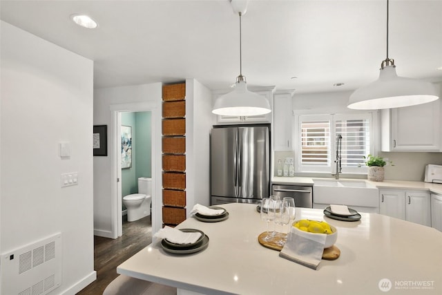 2643A NW 59th St, Seattle, WA 98107 - kitchen with appliances with stainless steel finishes, a sink, light countertops, dark wood-type flooring, and white cabinetry