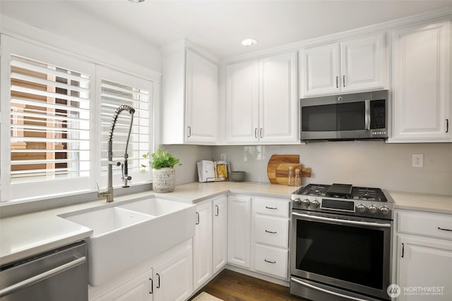 2643A NW 59th St, Seattle, WA 98107 - kitchen with stainless steel appliances, a sink, white cabinets, and light countertops