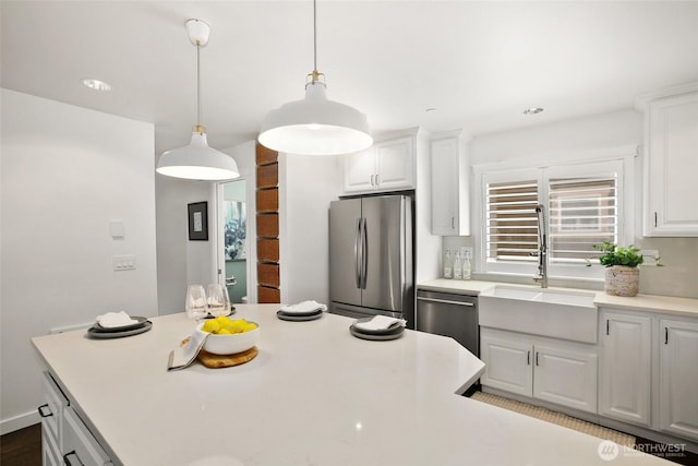 2643A NW 59th St, Seattle, WA 98107 - kitchen with appliances with stainless steel finishes, a sink, white cabinets, light countertops, and pendant lighting