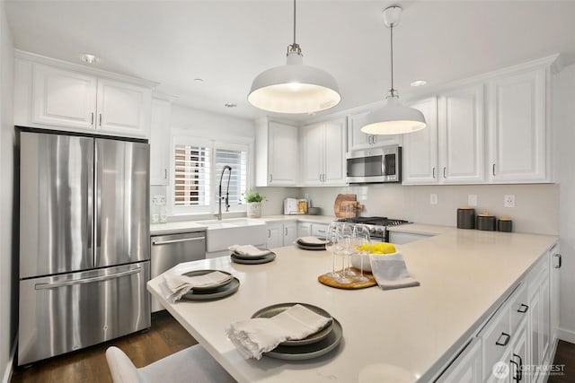 2643A NW 59th St, Seattle, WA 98107 - kitchen with stainless steel appliances, a sink, white cabinetry, and dark wood-type flooring