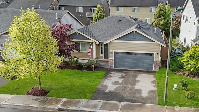 14429 98th Way SE, Yelm, WA 98597 - view of front of property featuring a garage, driveway, a front lawn, stone siding, and a residential view