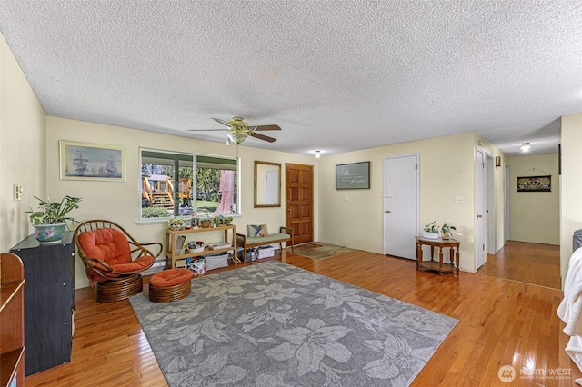 2 Quinault Way, La Conner, WA 98257 - living area featuring light wood-style flooring, a textured ceiling, and a ceiling fan