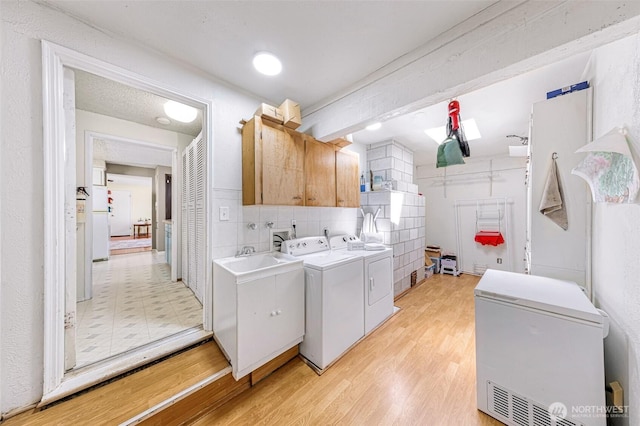 2 Quinault Way, La Conner, WA 98257 - washroom with cabinet space, independent washer and dryer, and light flooring