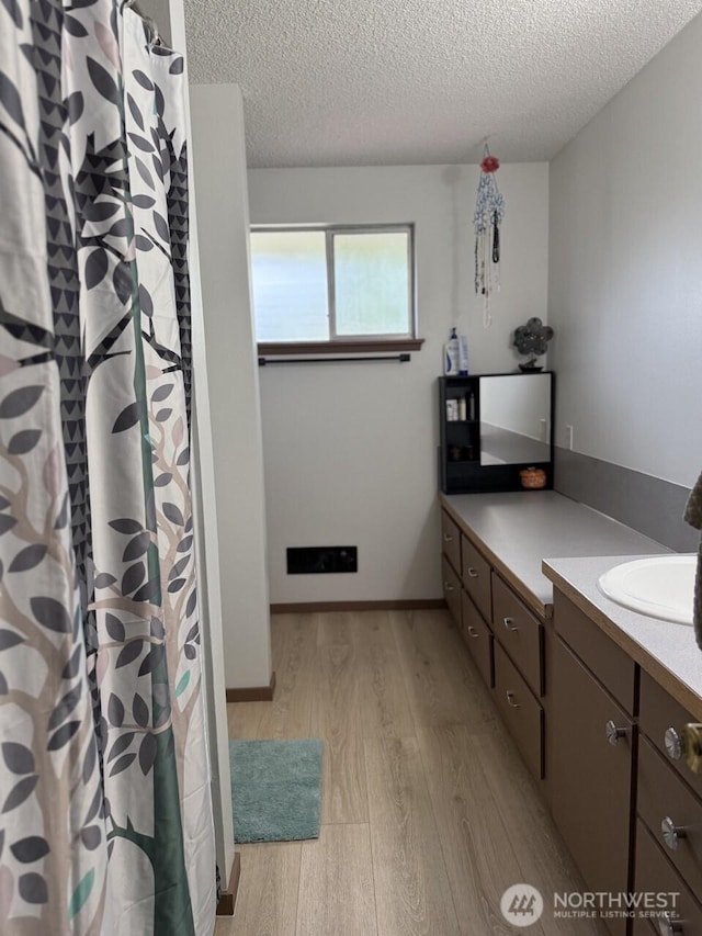 2 Quinault Way, La Conner, WA 98257 - full bathroom with wood finished floors, a textured ceiling, vanity, and curtained shower
