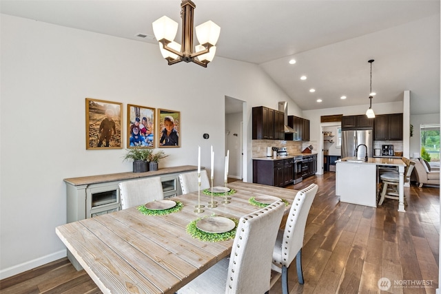 144 Faun Rae Ln, Chehalis, WA 98532 - dining space with a chandelier, recessed lighting, vaulted ceiling, dark wood-style floors, and baseboards