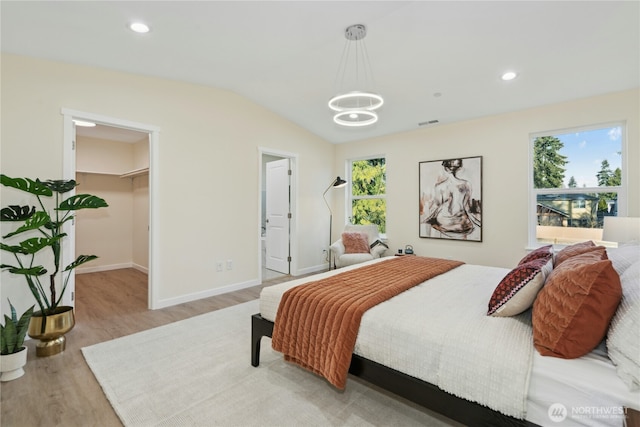 121 120th St SE Unit B, Everett, WA 98208 - bedroom featuring a chandelier, light wood-type flooring, vaulted ceiling, a spacious closet, and recessed lighting