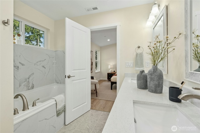 121 120th St SE Unit B, Everett, WA 98208 - bathroom with a bath, double vanity, connected bathroom, and tile patterned floors