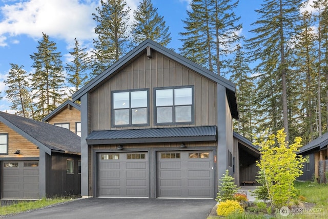 141 Panorama Dr, Cle Elum, WA 98922 - view of front of home featuring driveway, a garage, board and batten siding, and metal roof